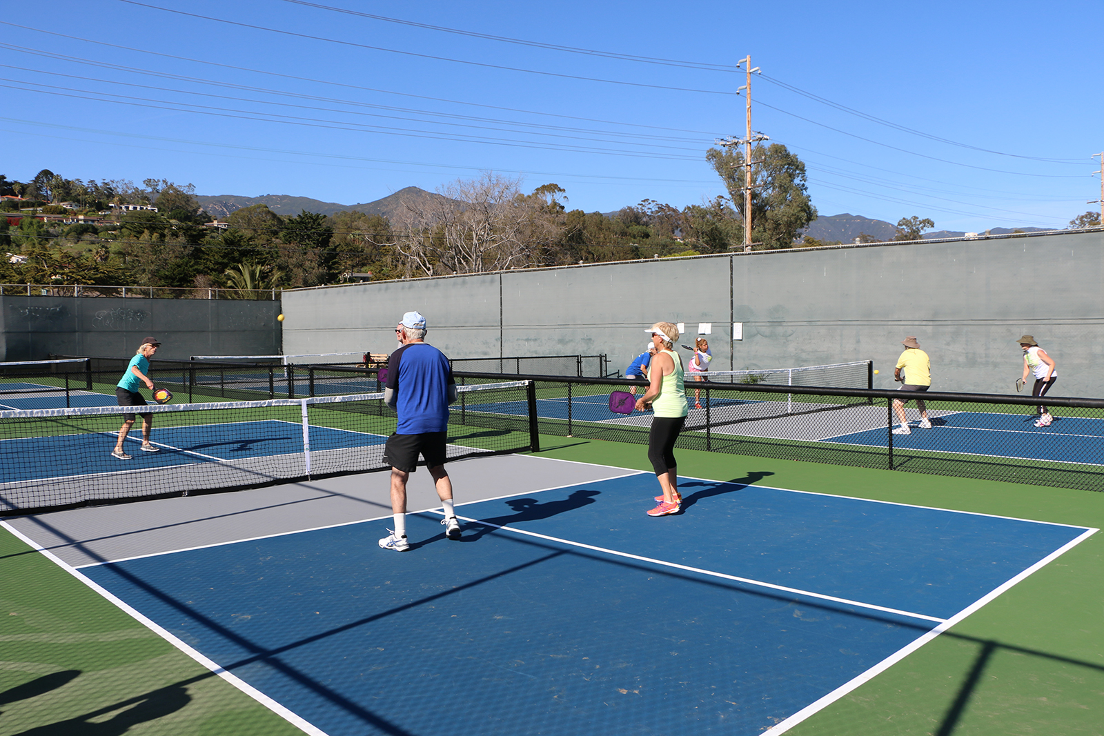 Community members play pickleball at the Municipal Tennis Courts