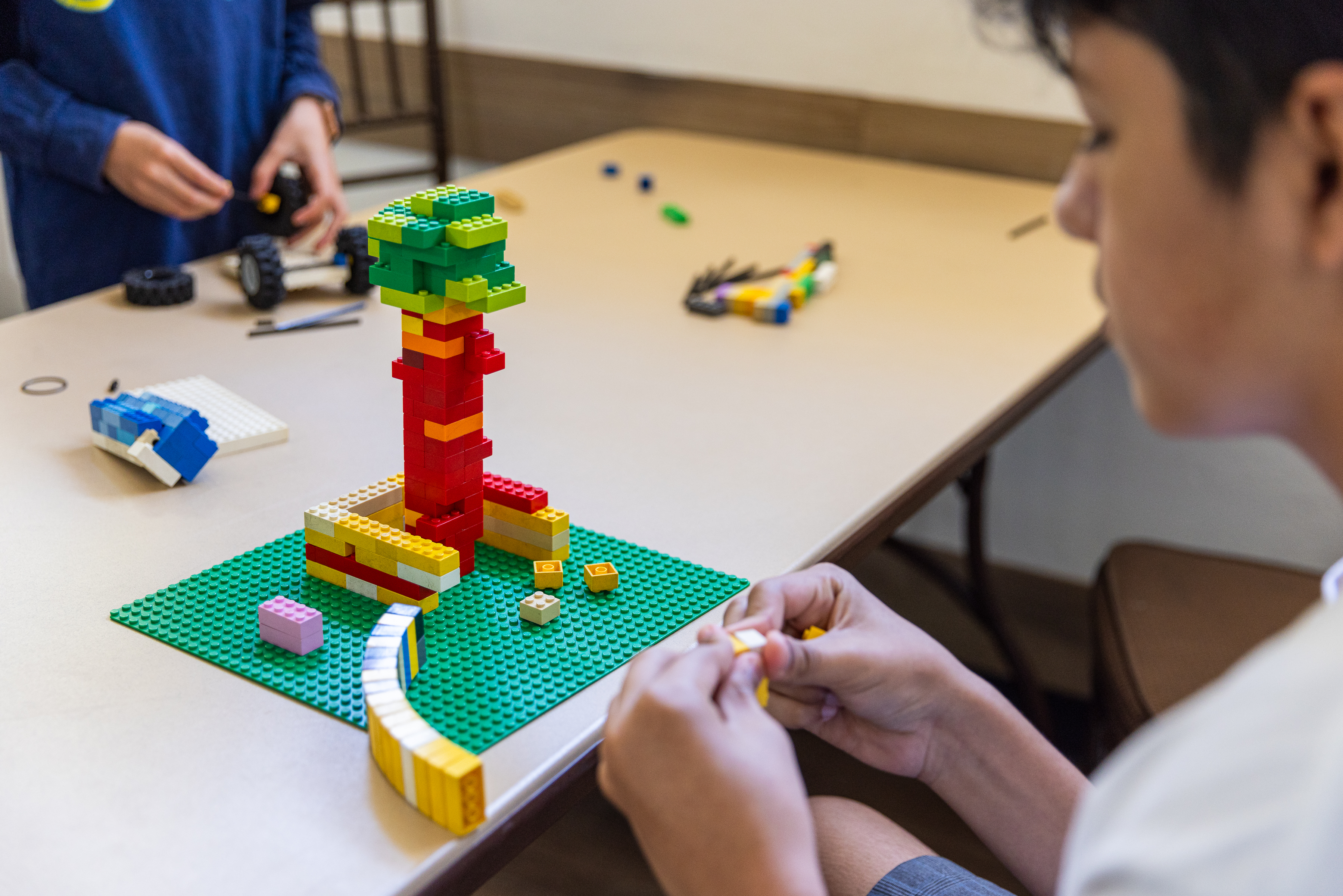 A camper works on their Lego creation with great focus