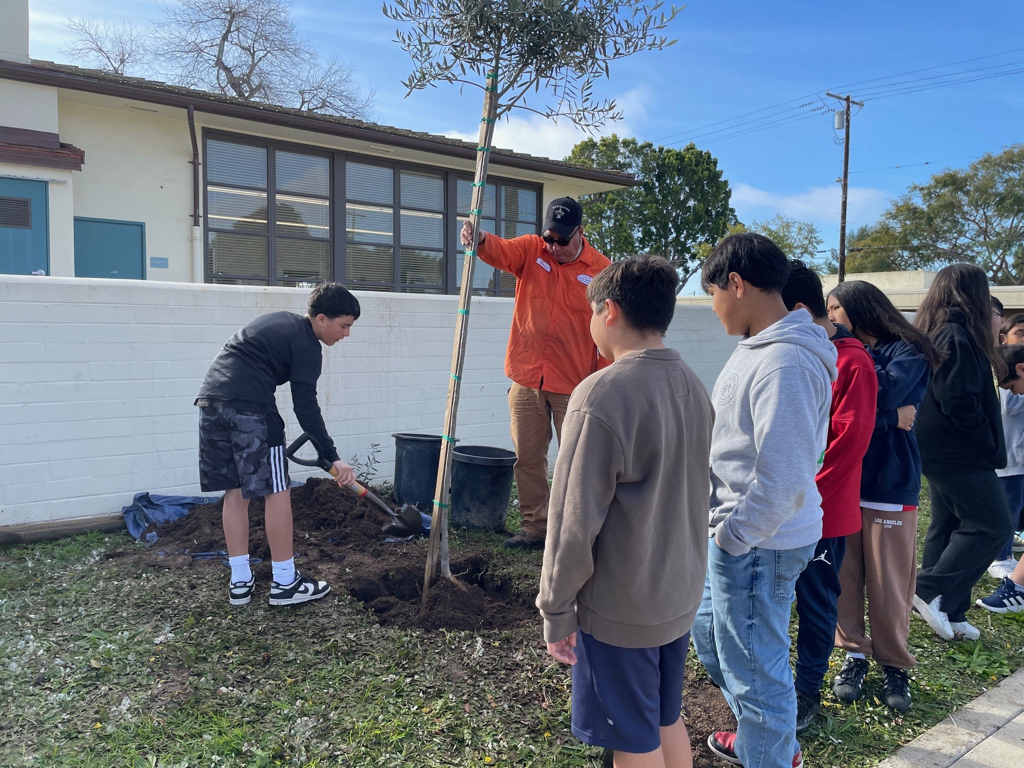 Students at Franklin Elementary help staff plant new trees during Arbor Week.