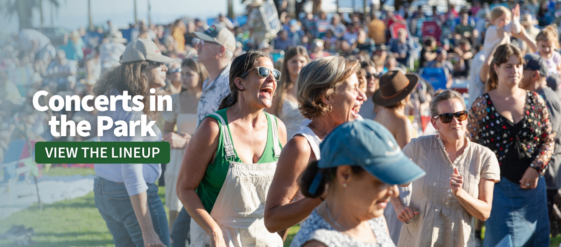 Concerts in the Park: View the lineup. In background people are dancing and singing at Concerts in the Park