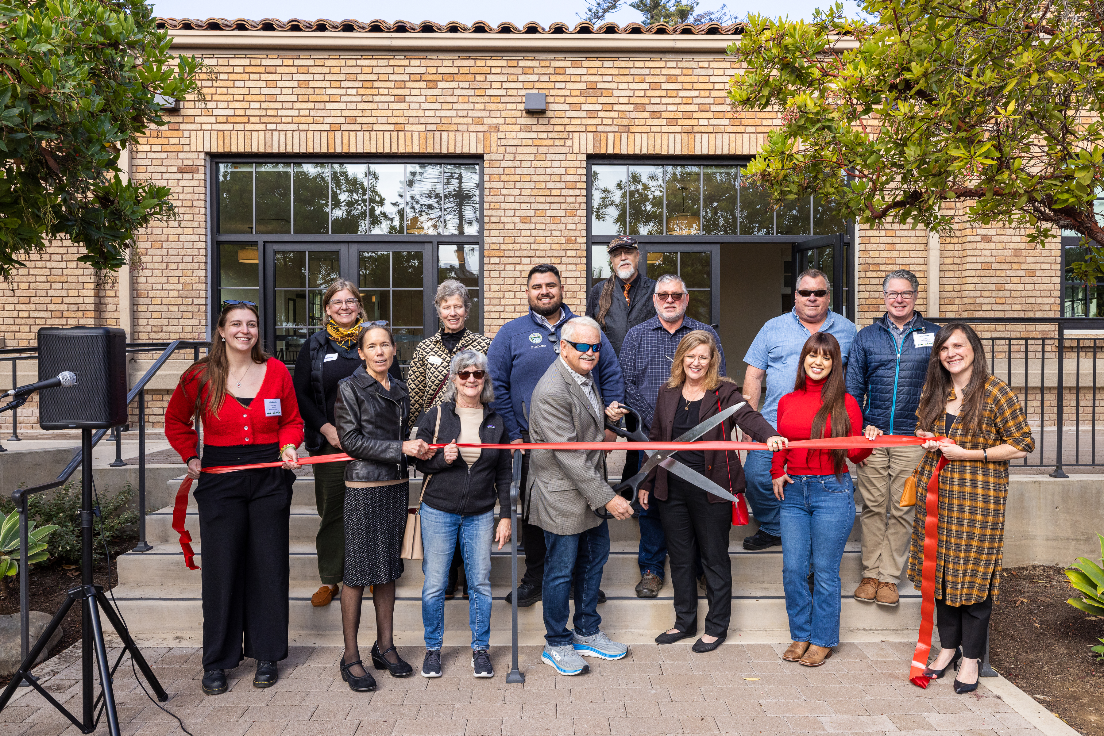 Mayor Randy Rowse cuts a red ribbon in front of the Louise Lowry Davis Center