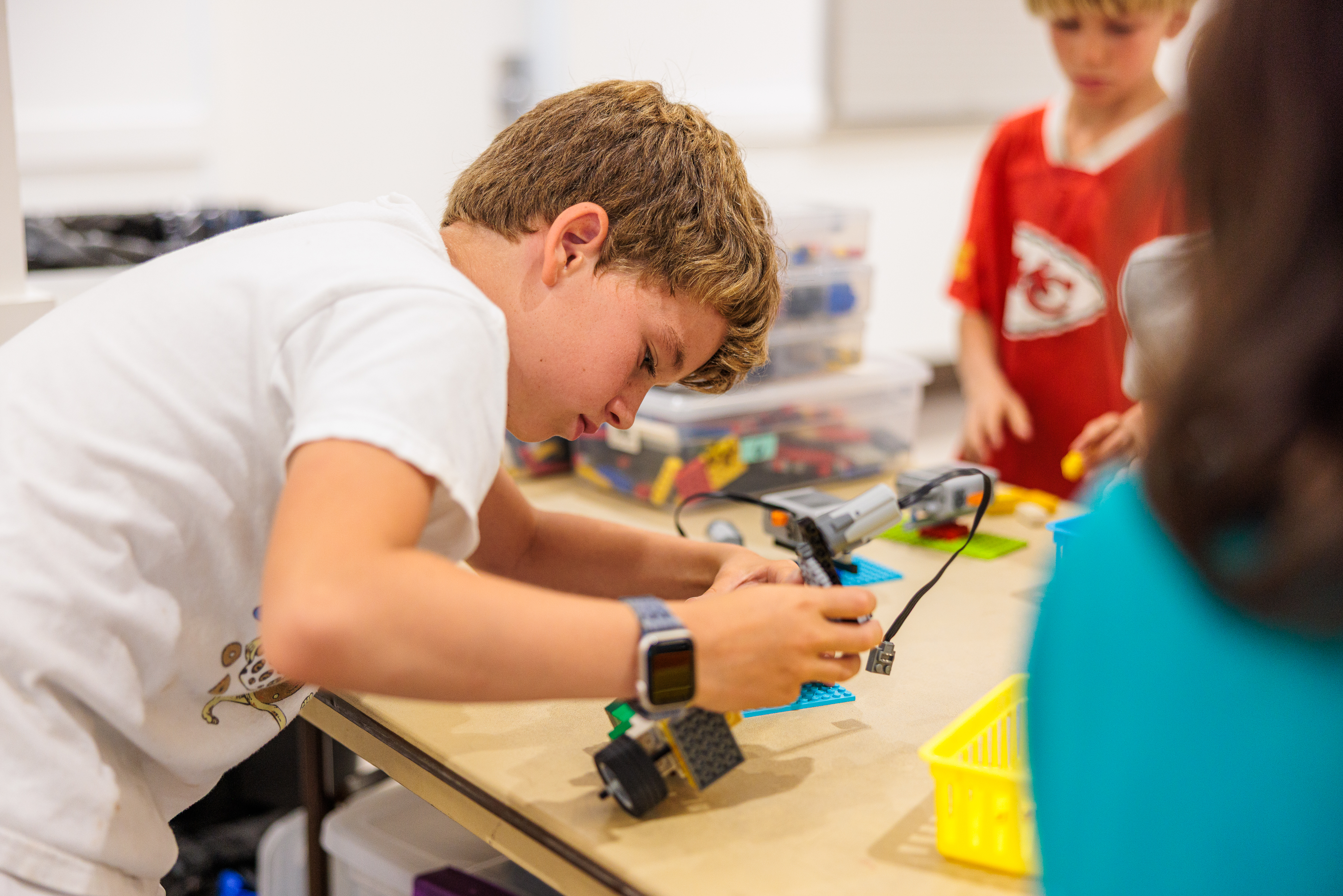 A camper at LEGO camp building with LEGOs
