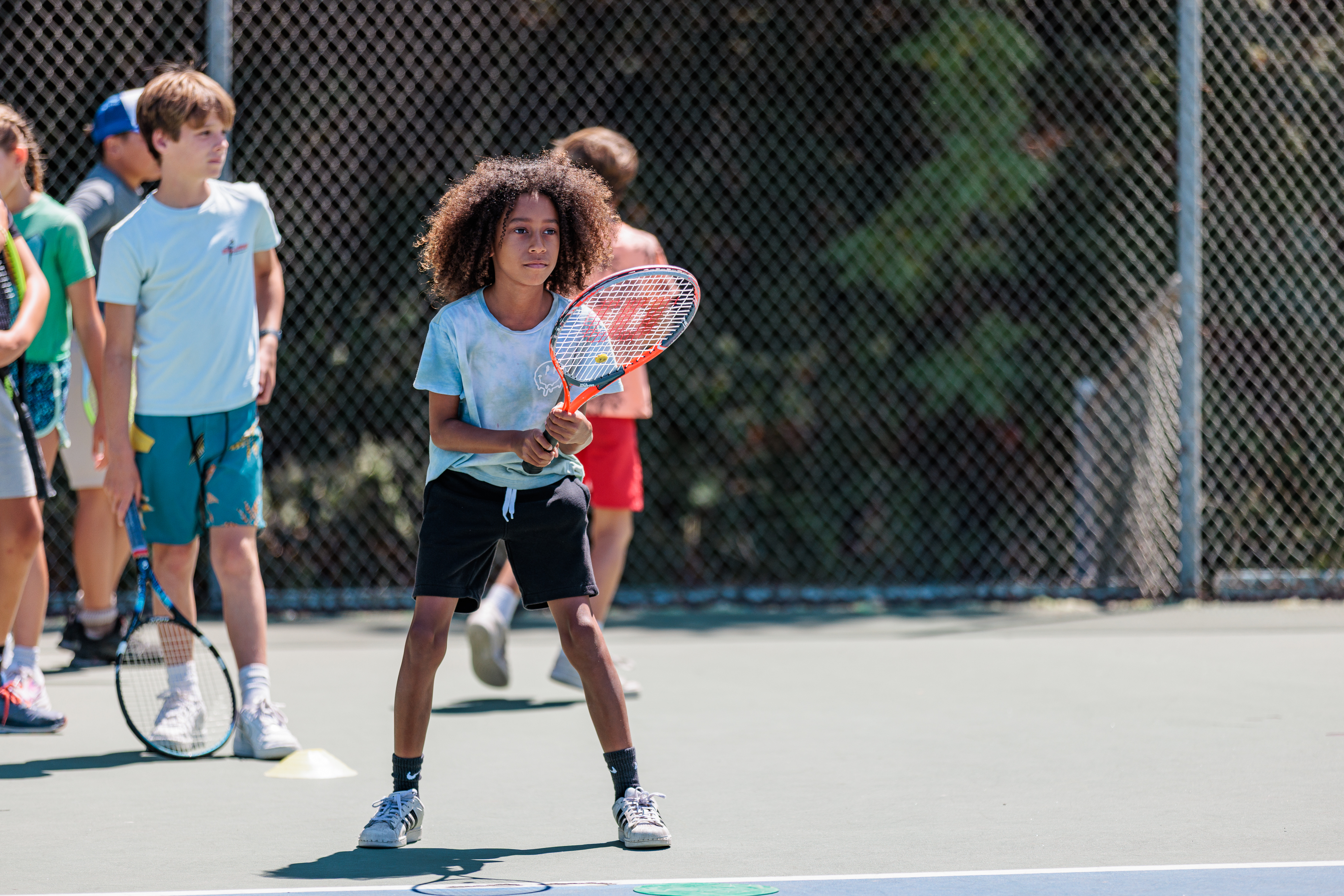 A camper at Tennis Camp holding a tennis racquet 