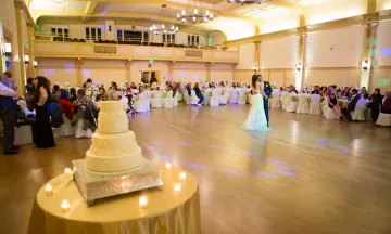 Wedding reception at Carrillo Ballroom with wedding cake in foreground