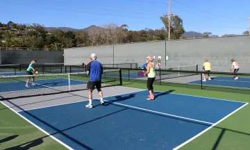 Community members play pickleball at the Municipal Tennis Courts