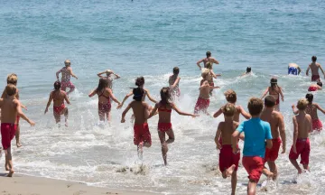 Jr. Guards running into the ocean