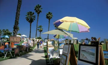 People stroll along the sidewalk of Chase Palm Park during the Santa Barbara Arts and Crafts Shows