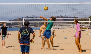 Campers at Volleyball Camp play a game on East Beach