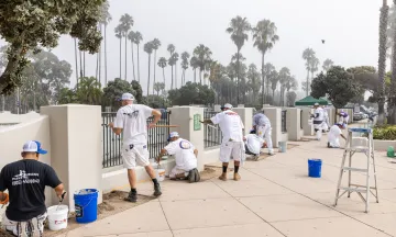 Painters from local companies painting the walls of Skater's Point skatepark