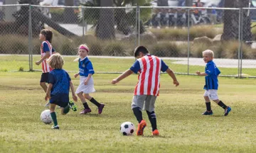 Campers pass the soccer balls while running around