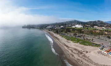 Aerial view of Leadbetter Beach, sand and grassy area.