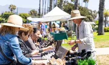 Vistiors to the Santa Barbara Arts and Crafts show browse handmade items
