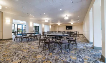 Tables and chairs set up for an event in Palm Park Beach House 