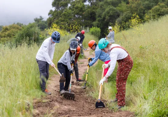 Volunteer trail workers level the dirt on Jesusita Trail