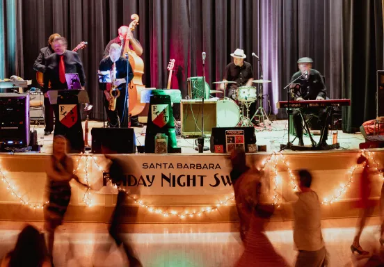 Participants swing dance to live music in the Carrillo Ballroom