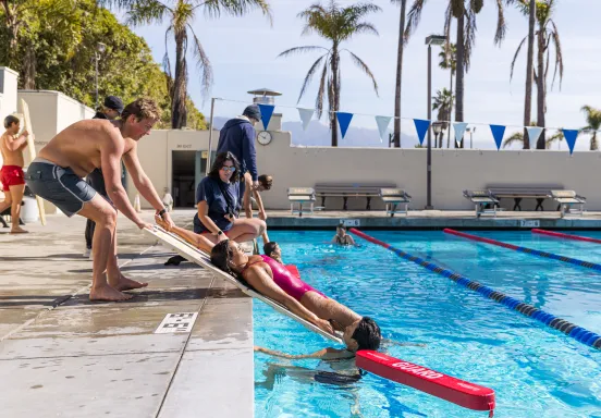 Lifeguard trainees practice water rescues at Los Baños del Mar.