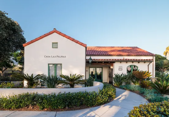 Casa Las Palmas entrance with walkway lined with plants