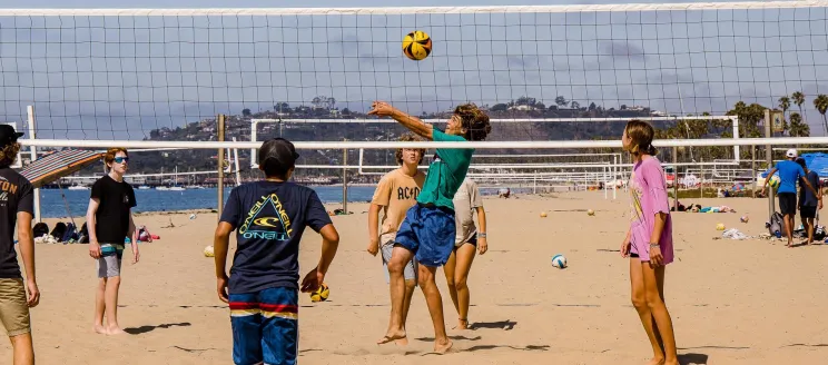 Campers at Volleyball Camp play a game on East Beach