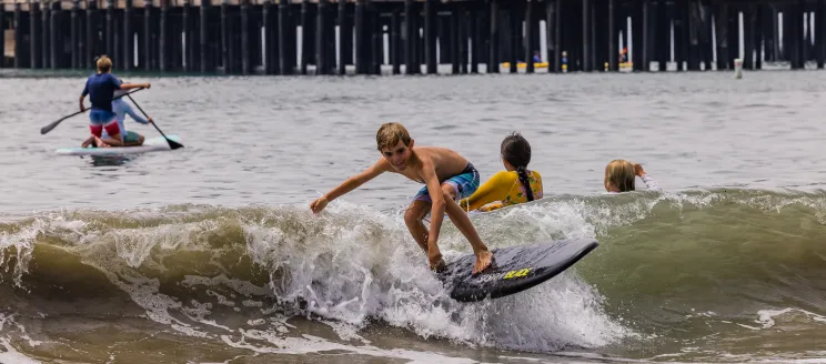 Participants at summer camp enjoy different water activities near Stearns Wharf