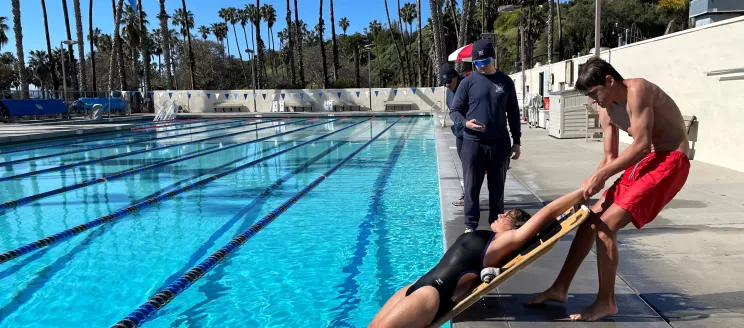 Lifeguard certification course participants practice water rescues