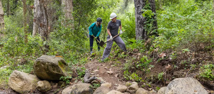 Volunteers work during a trail restoration event