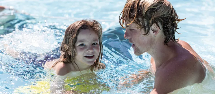 Young swimmer receives instruction from Swim Instructor at Ortega Park Pool