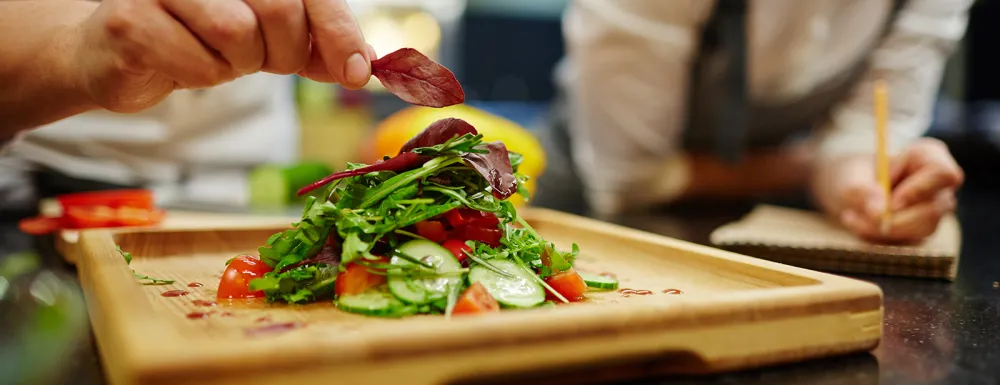 Chefs prepare a salad
