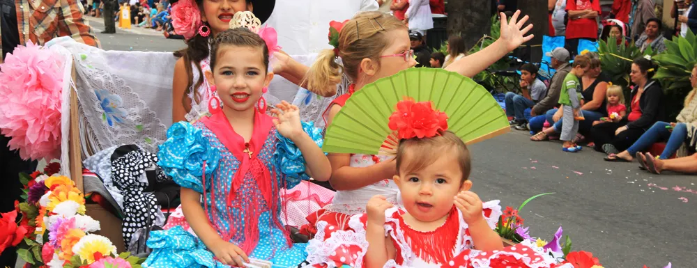 Girls in costume participate in the Children's Fiesta Parade