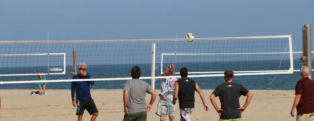 Community members play volleyball on East Beach