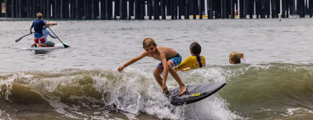 Participants at summer camp enjoy different water activities near Stearns Wharf