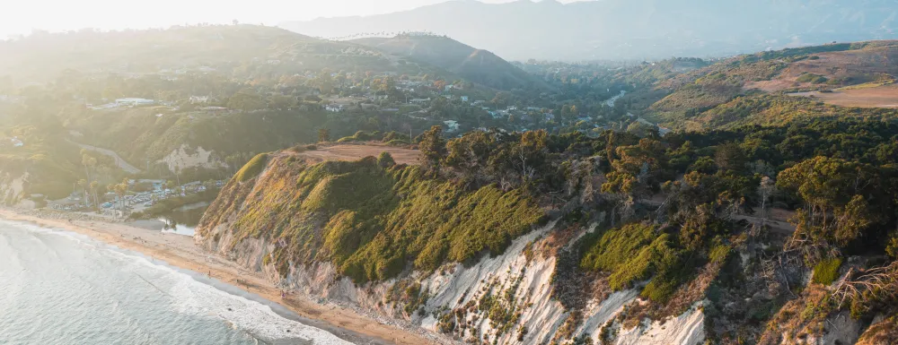 Aerial view shows the cliffs and trails of the Douglas Family Preserve over the ocean