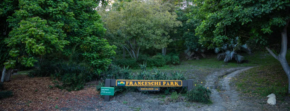 Picture of Franceschi Park entrance sign and walking path to the right