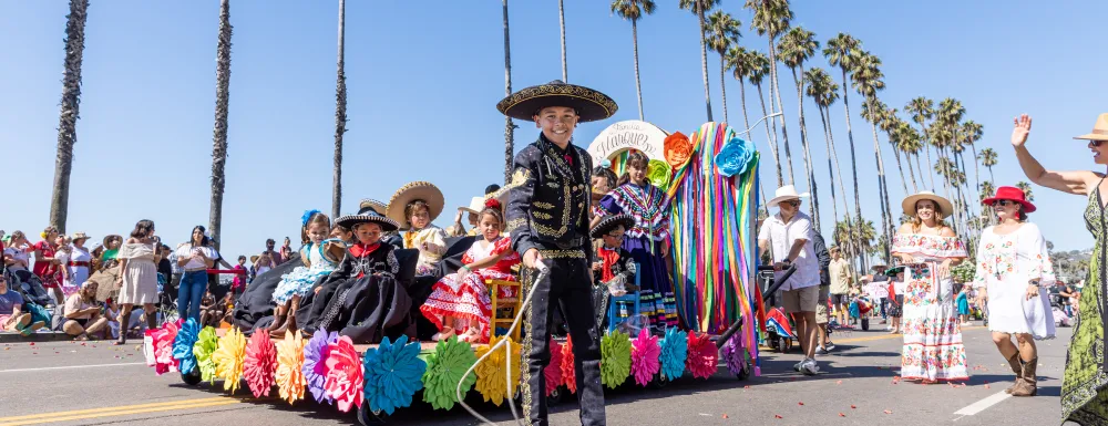 Children's Fiesta Parade colorful float with participants all smiles.