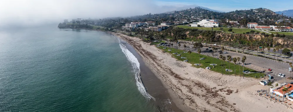Aerial view of Leadbetter Beach, sand and grassy area.
