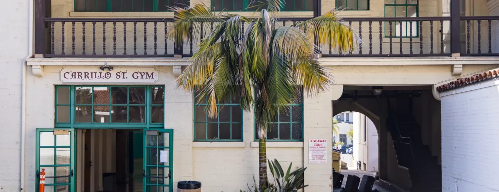 Exterior photo of the Carrillo Street Gymnasium with the front doors propped open