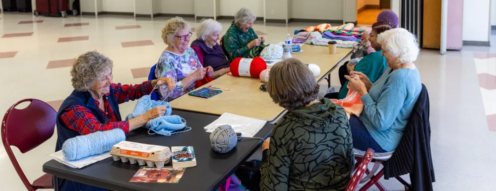 A group of women knitting together at the Westside Neighborhood Center