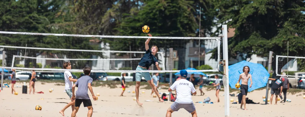 Campers play beach volleyball