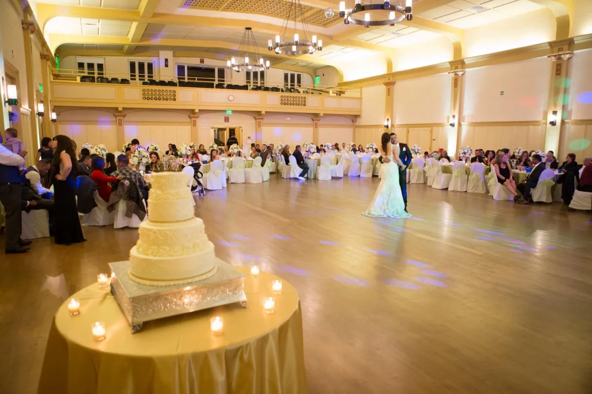 Wedding reception at Carrillo Ballroom with wedding cake in foreground