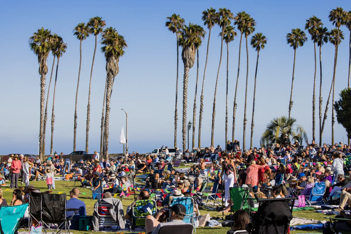 People on blankets and lawn chairs enjoying Concerts in the Park