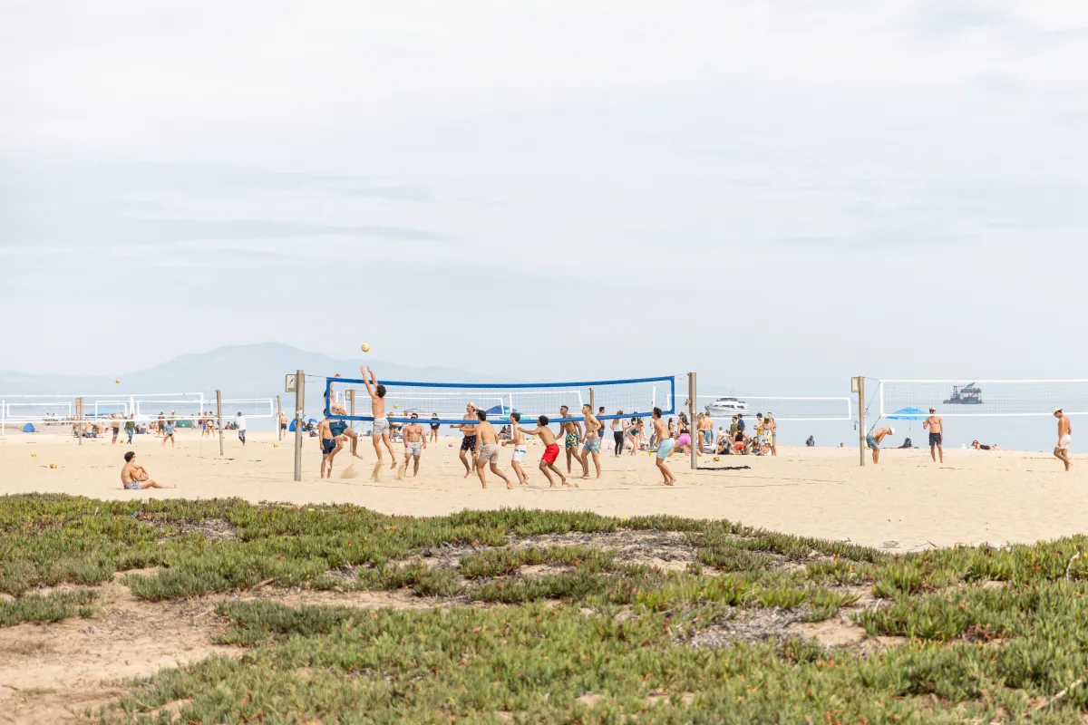 Community members play beach volleyball at East Beach