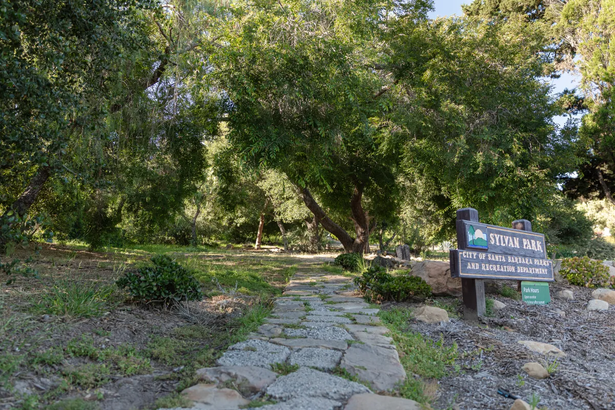 Stone walkway at Sylvan Park with the park sign on the right side