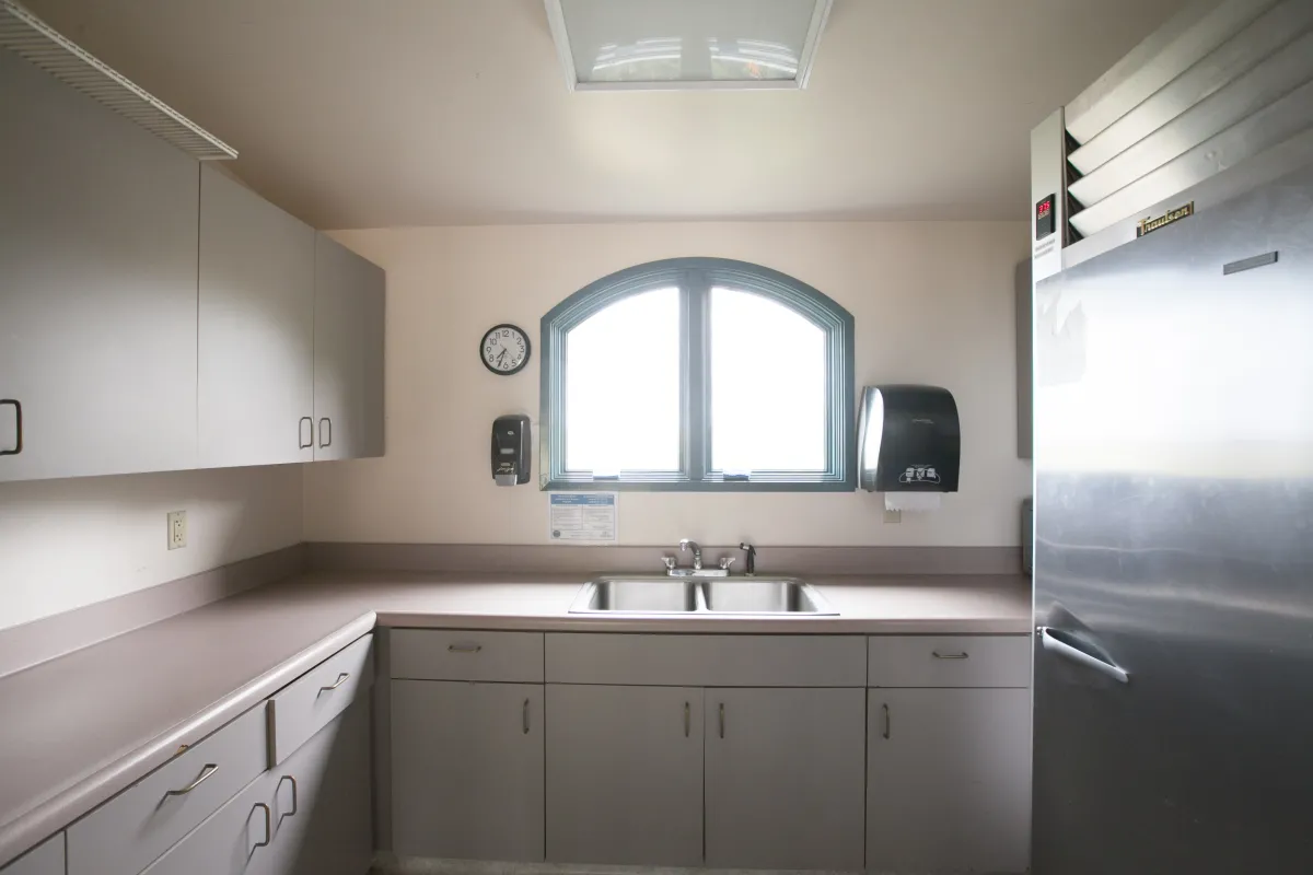 Casa Las Palmas small kitchen with sink, counters, and refrigerator