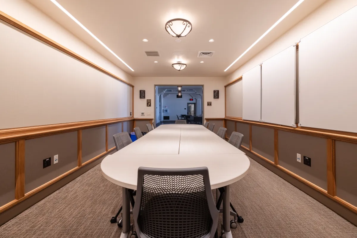 Cabrillo Pavilion conference room with a conference table with 10 chairs, and white boards on the side walls