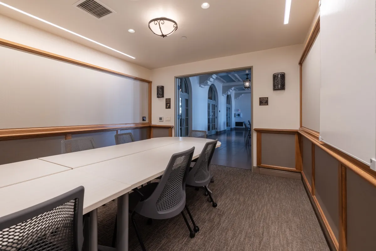 Cabrillo Pavilion conference room with a conference table and 10 chairs, featuring a television on the end wall and white boards on the side walls