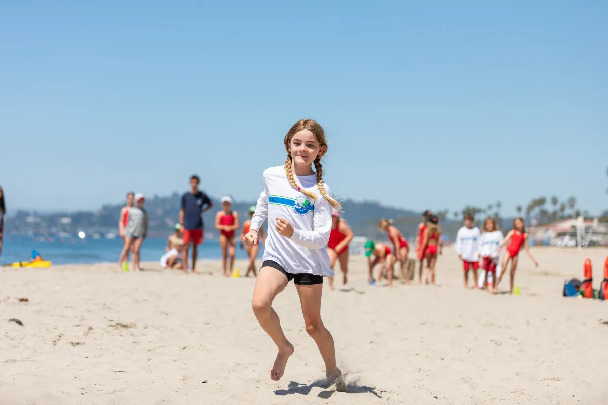 Junior Lifeguard camper running on East Beach