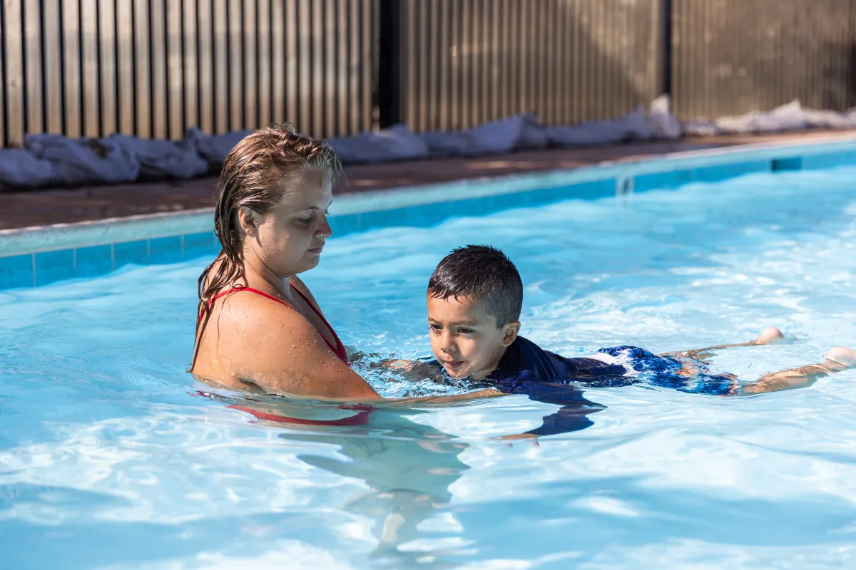 Young swimmer receives instruction from Swim Instructor at Ortega Park Pool