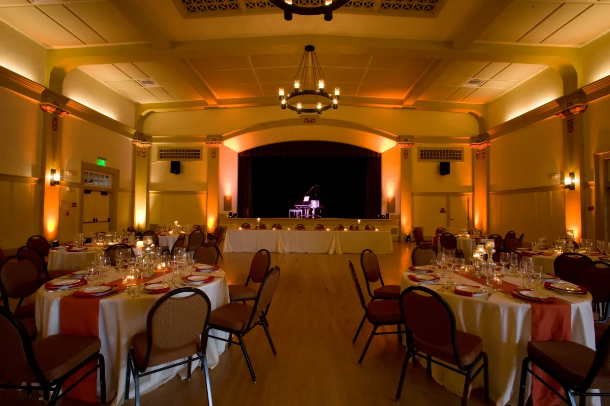 Carrillo Ballroom with tables set with white tablecloths and the piano on the stage