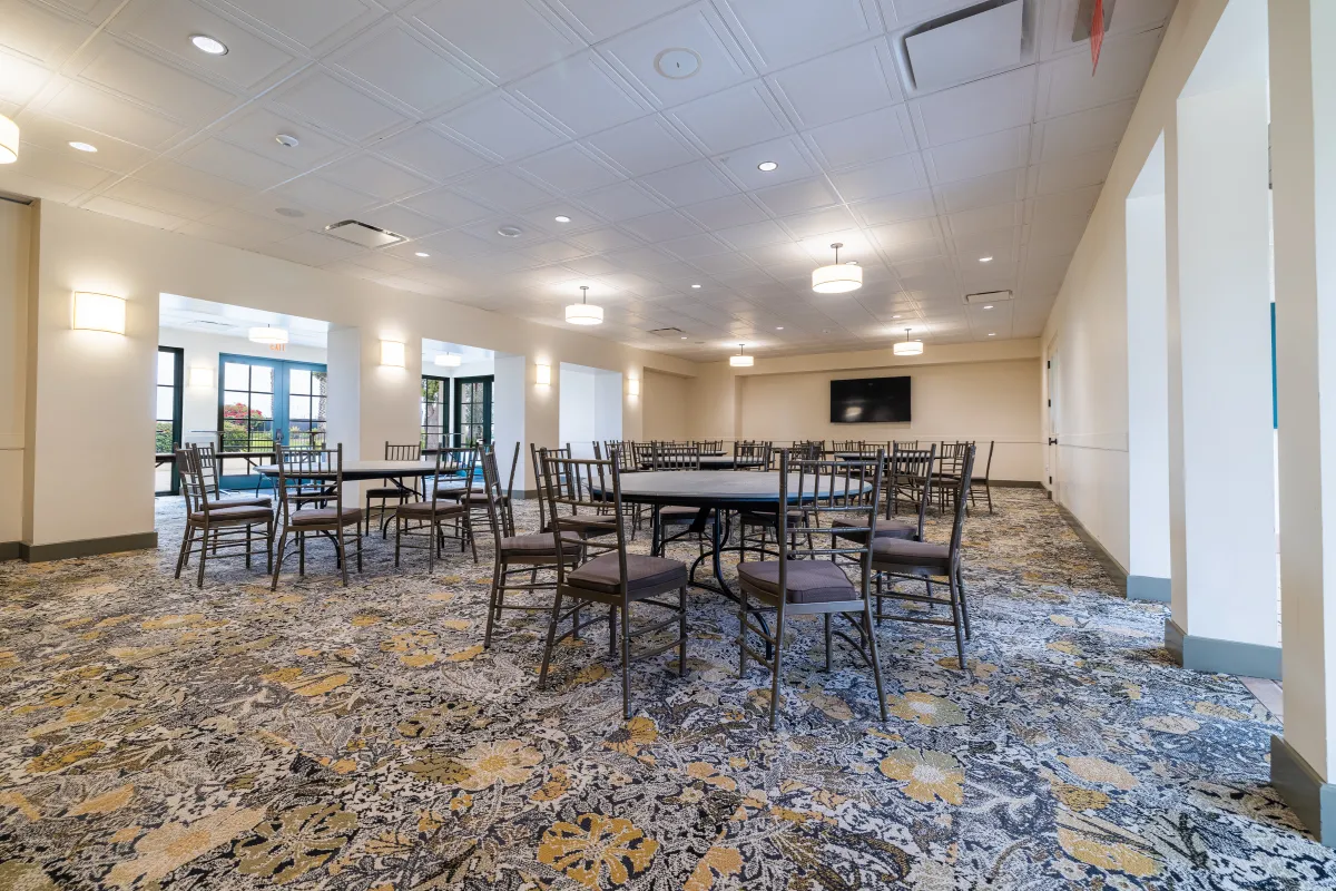 Tables and chairs set up for an event in Palm Park Beach House 