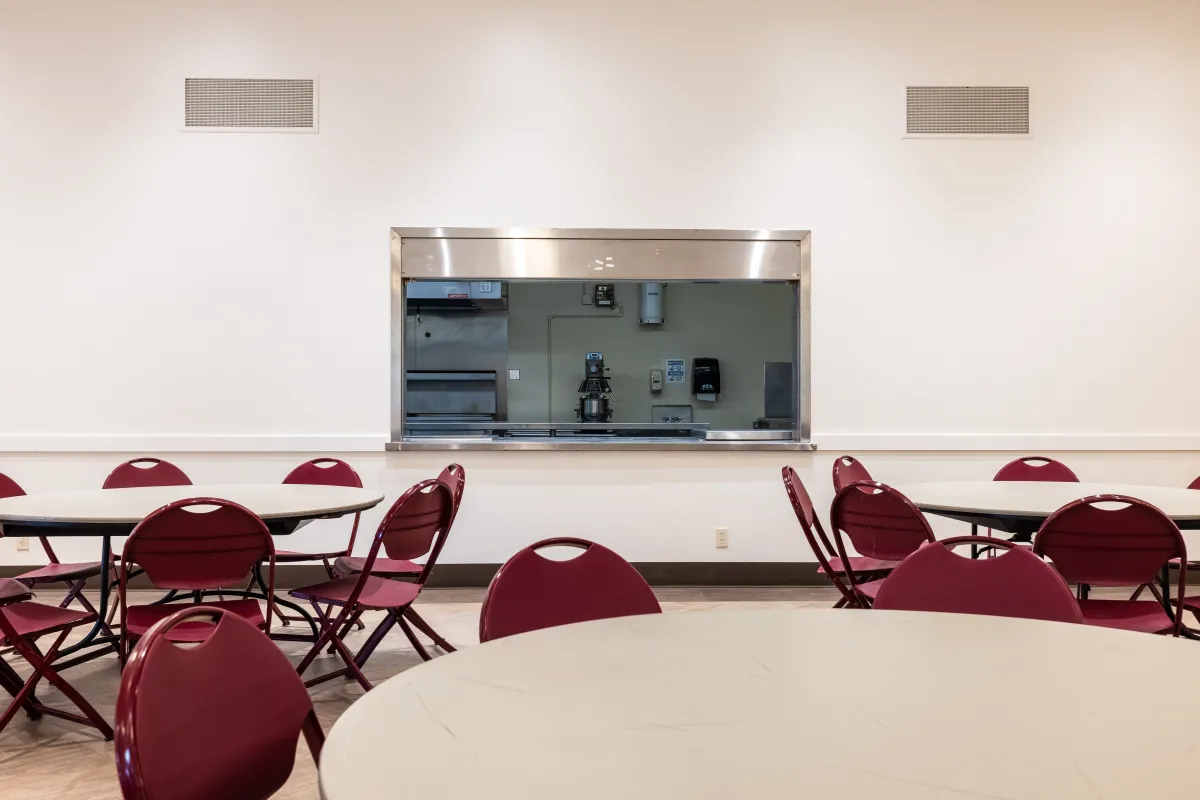 View of the kitchen window in Westside Neighborhood Center from the main room