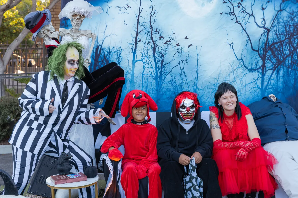 children posing in their costumes at trunk or treat
